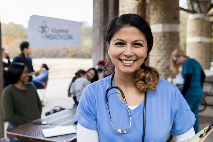 The mid adult female volunteer doctor pauses for a portrait at the free clinic held in a local park.